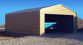A blue truck is parked in a garage with the door open.