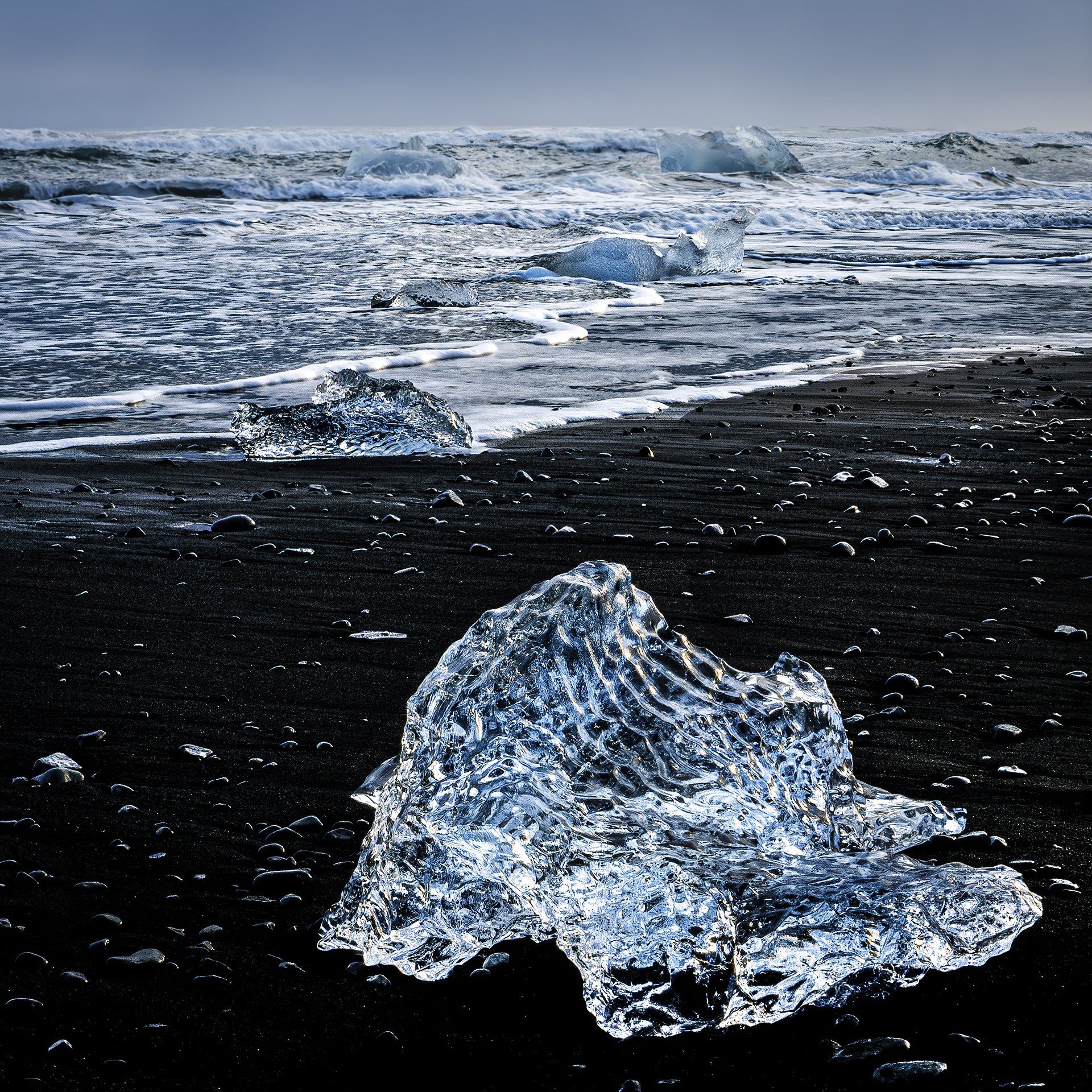 Crystal Clear Ice on a Black Beach