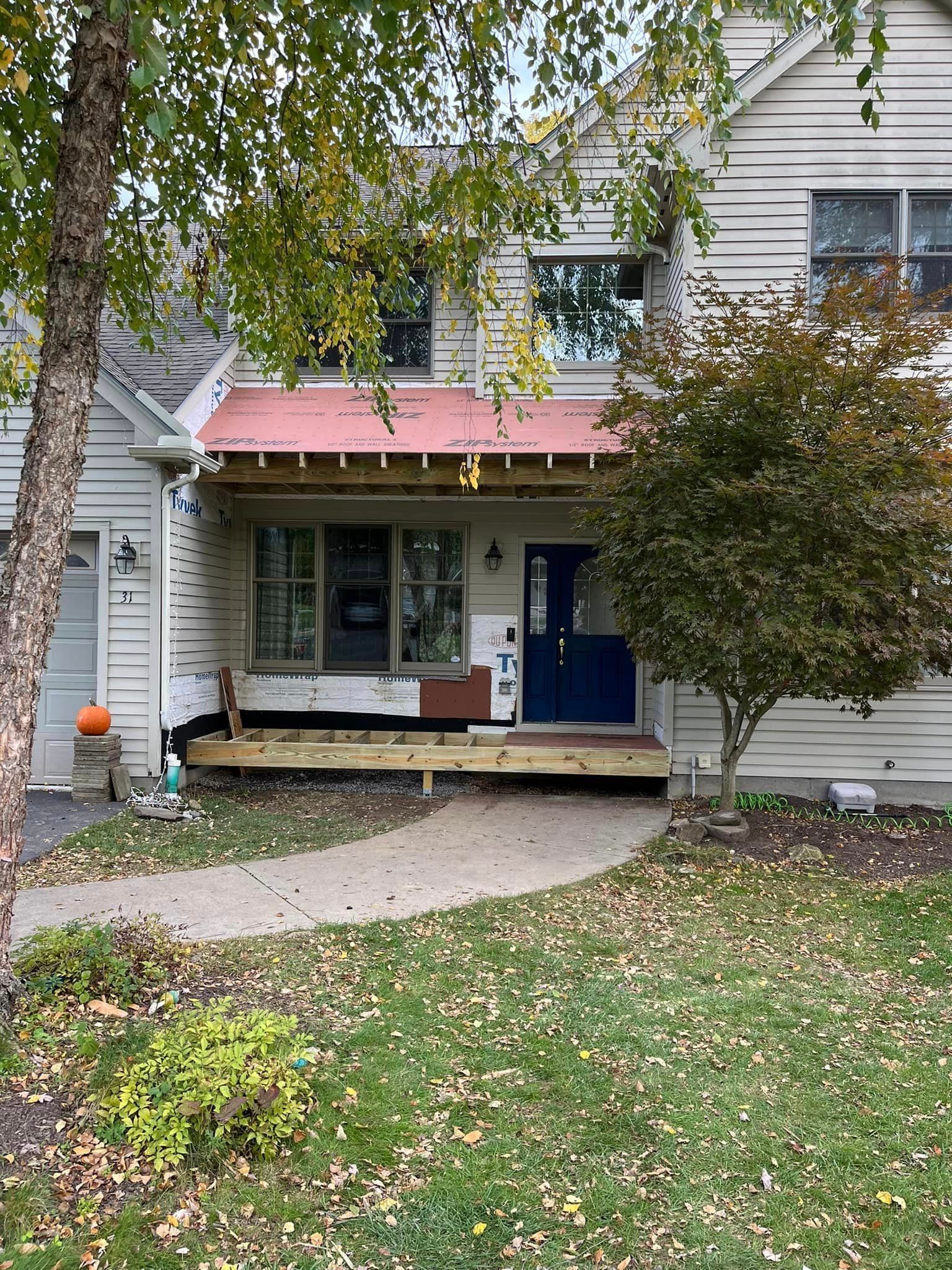 A house with a red awning on the front porch.