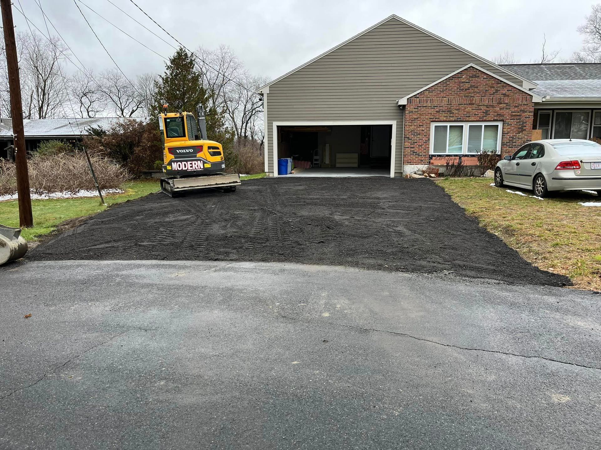 A living room with a sectional couch and a lamp.