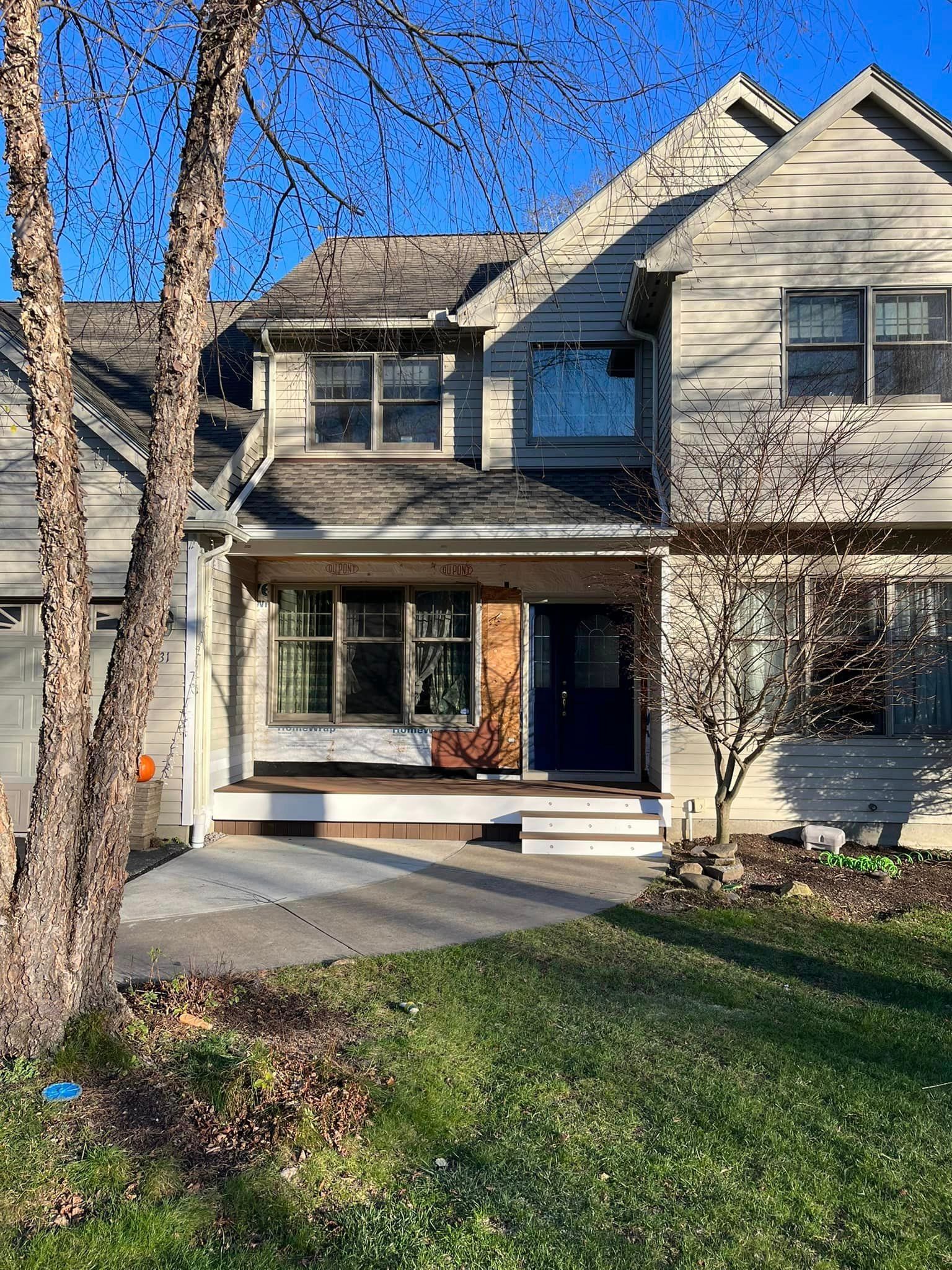 A large house with a tree in front of it.