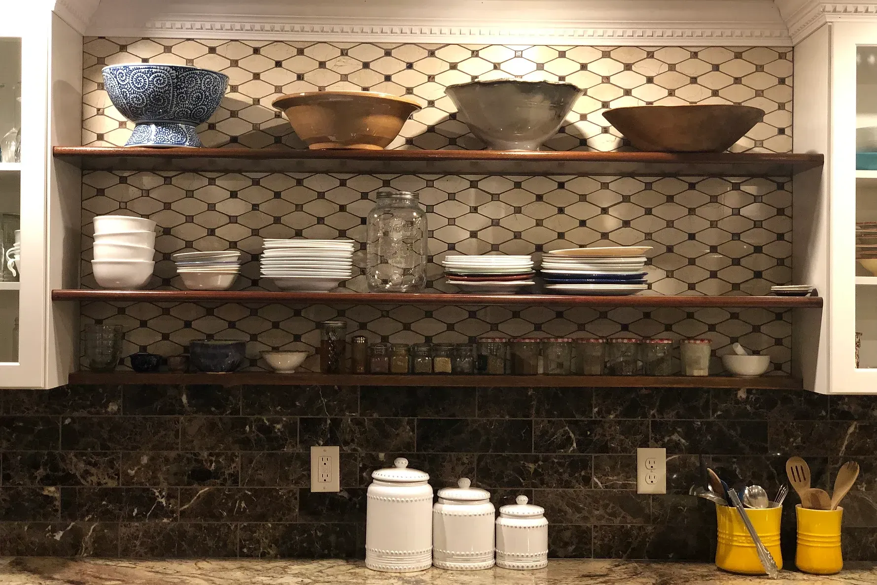 A kitchen with granite countertops and a stovetop oven.