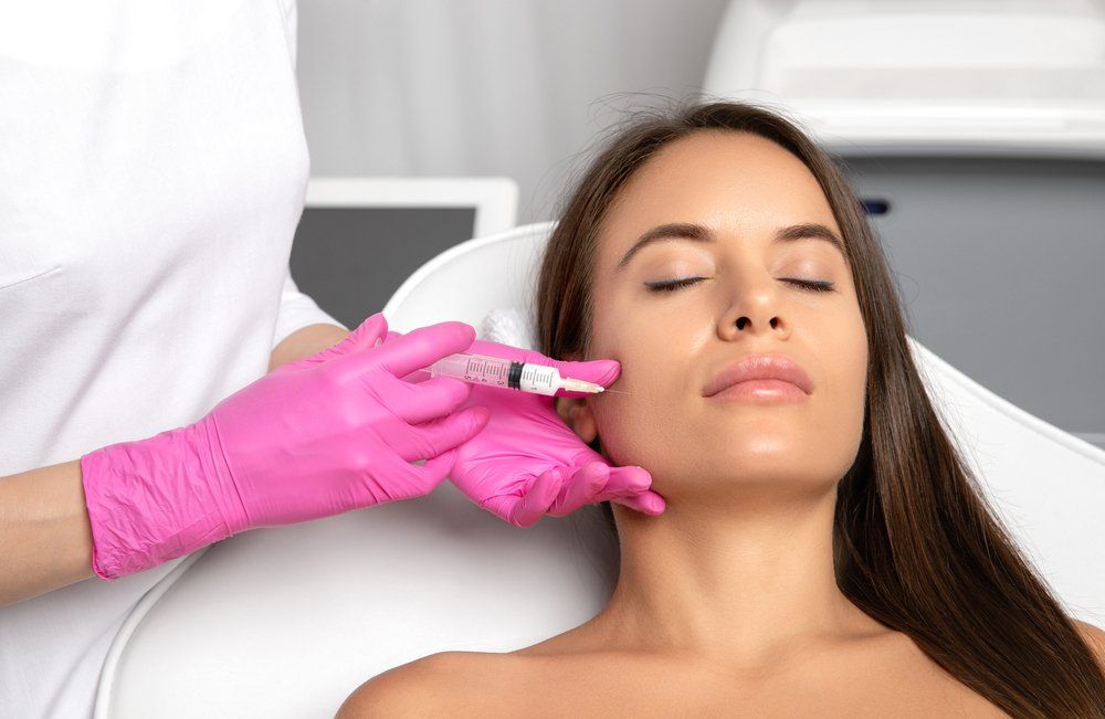 Cosmetologist Administering Cosmetic Injections — Cosmetic Clinic in Wollongong