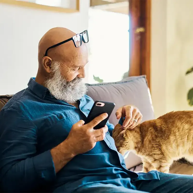 A man calling while petting a cat