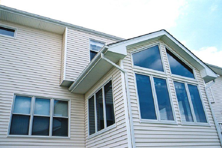 Siding Installation — House with Multiple Clear Windows in Lincoln, NE