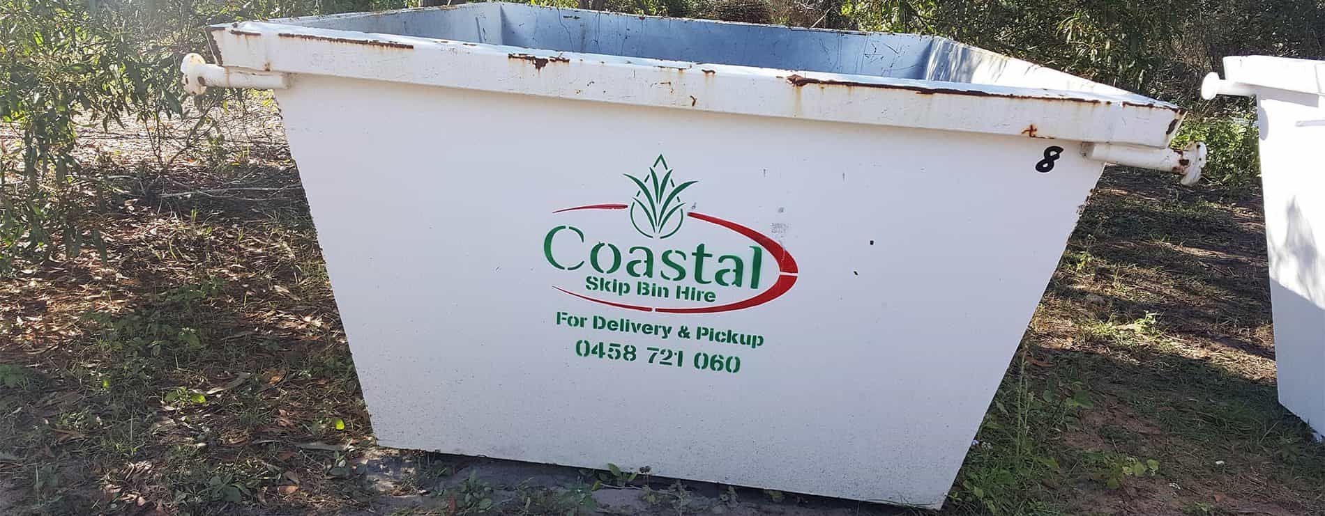White Dumpster in A Grassy Area — Coastal Skip Bin Hire In Craignish, QLD