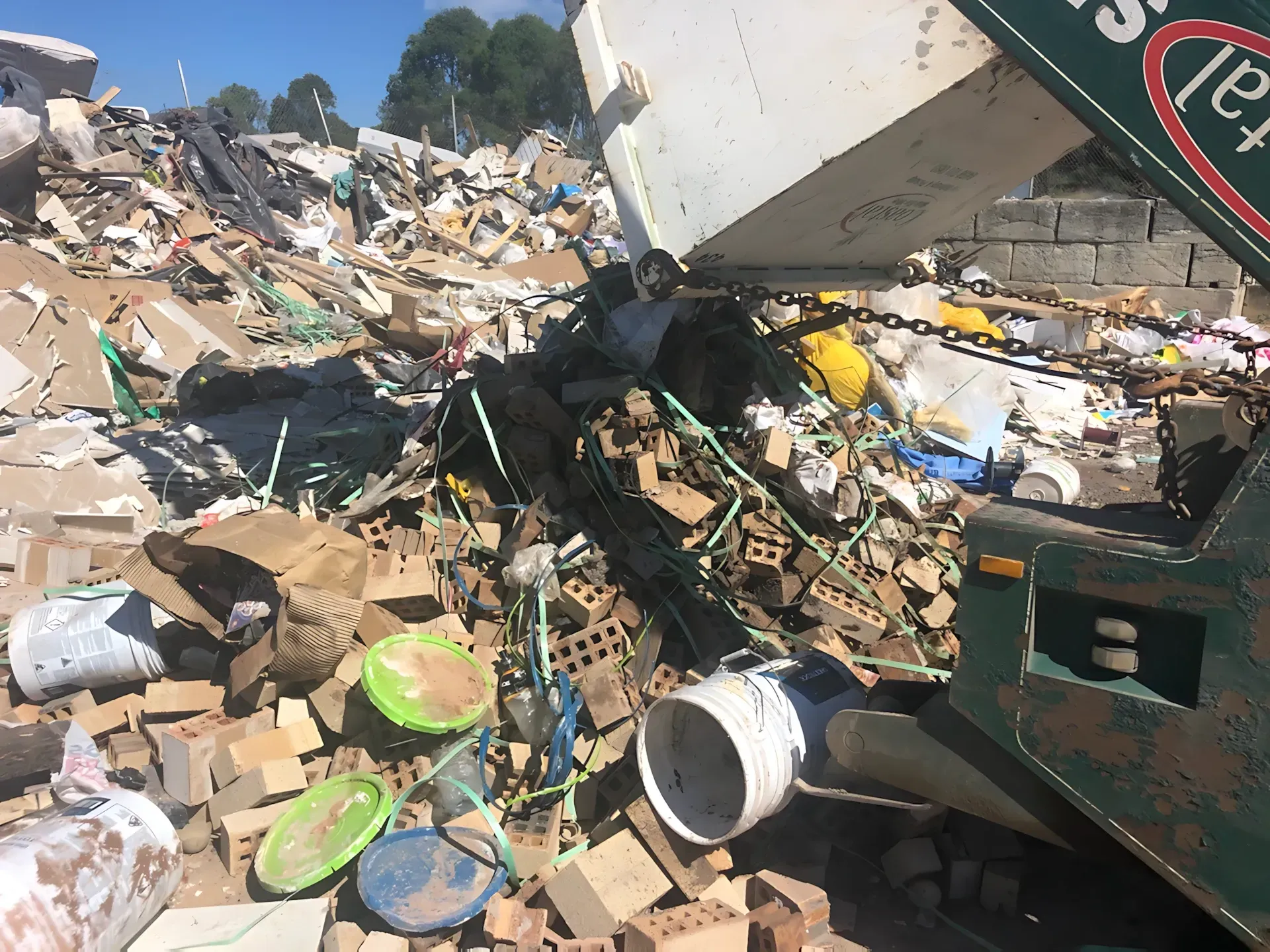 A truck dumping rubble, including bricks and debris, outdoors. — Coastal Skip Bin Hire In Craignish, QLD
