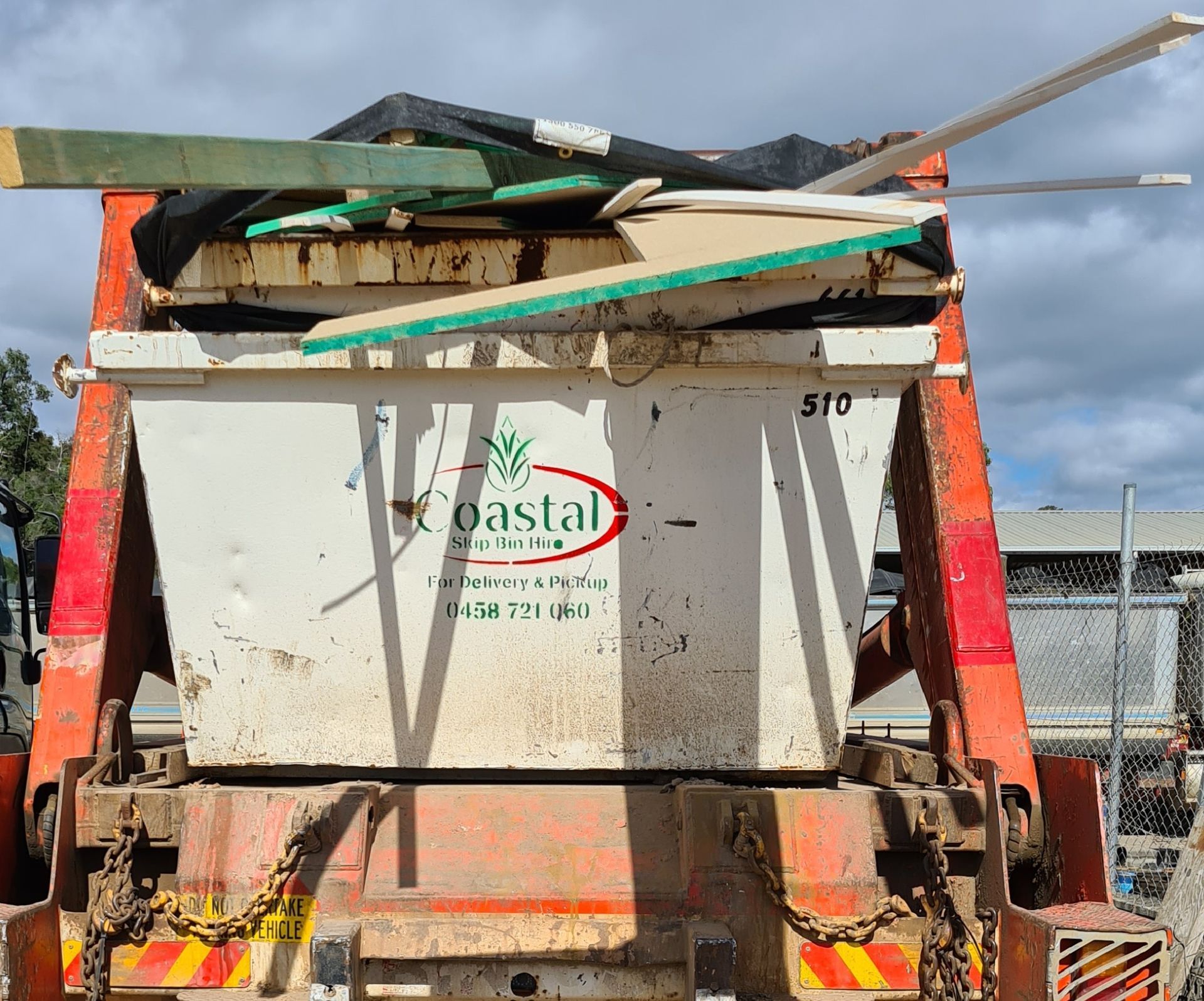 Yellow Dumpster Overflowing with Construction Debris — Coastal Skip Bin Hire In Fraser Coast, QLD