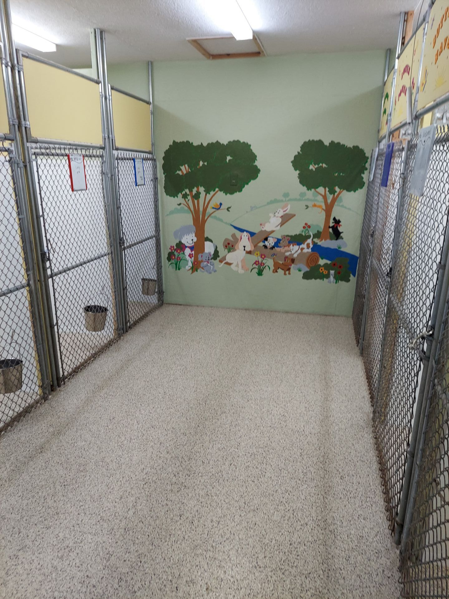 A room with a painting of animals on the wall