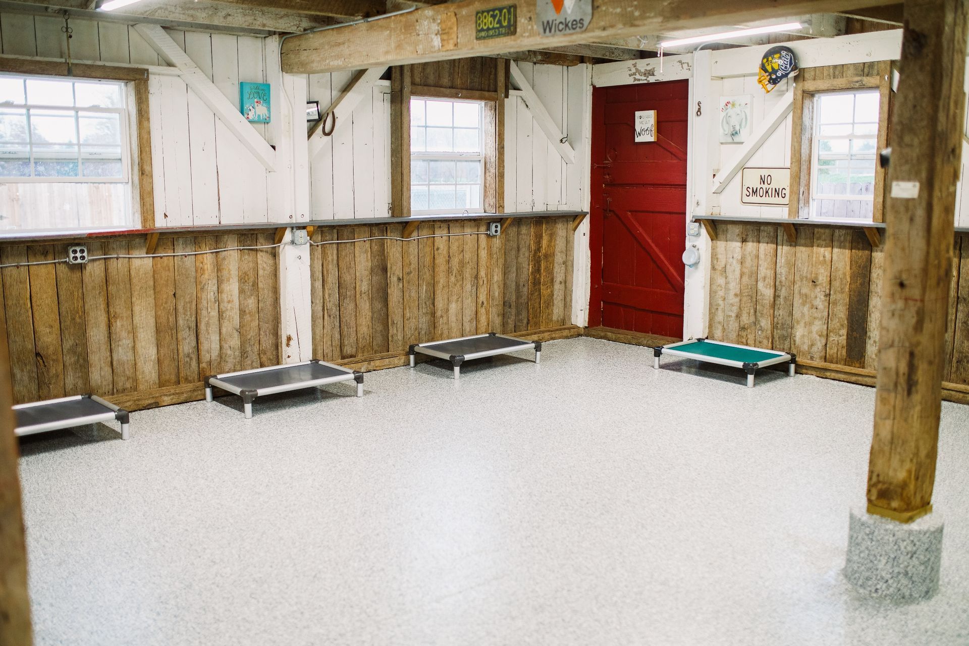 An empty room with a red door and a sign that says exit