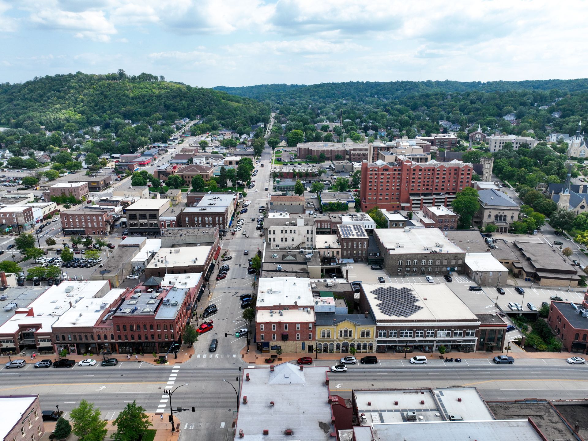 An aerial view of a small town with a hill in the background.