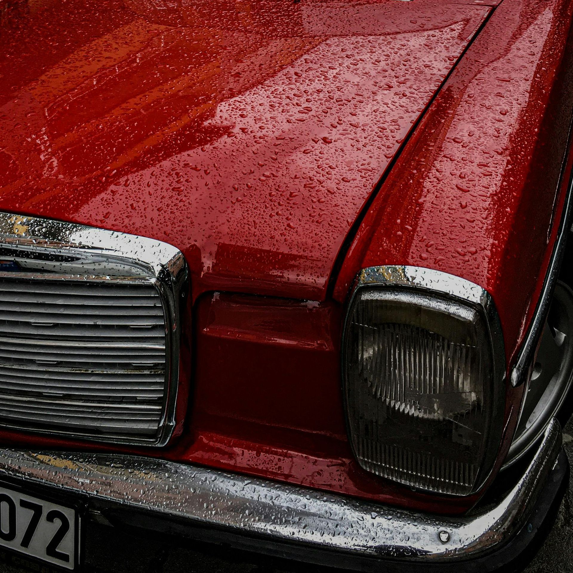 A red car with a license plate that says 072