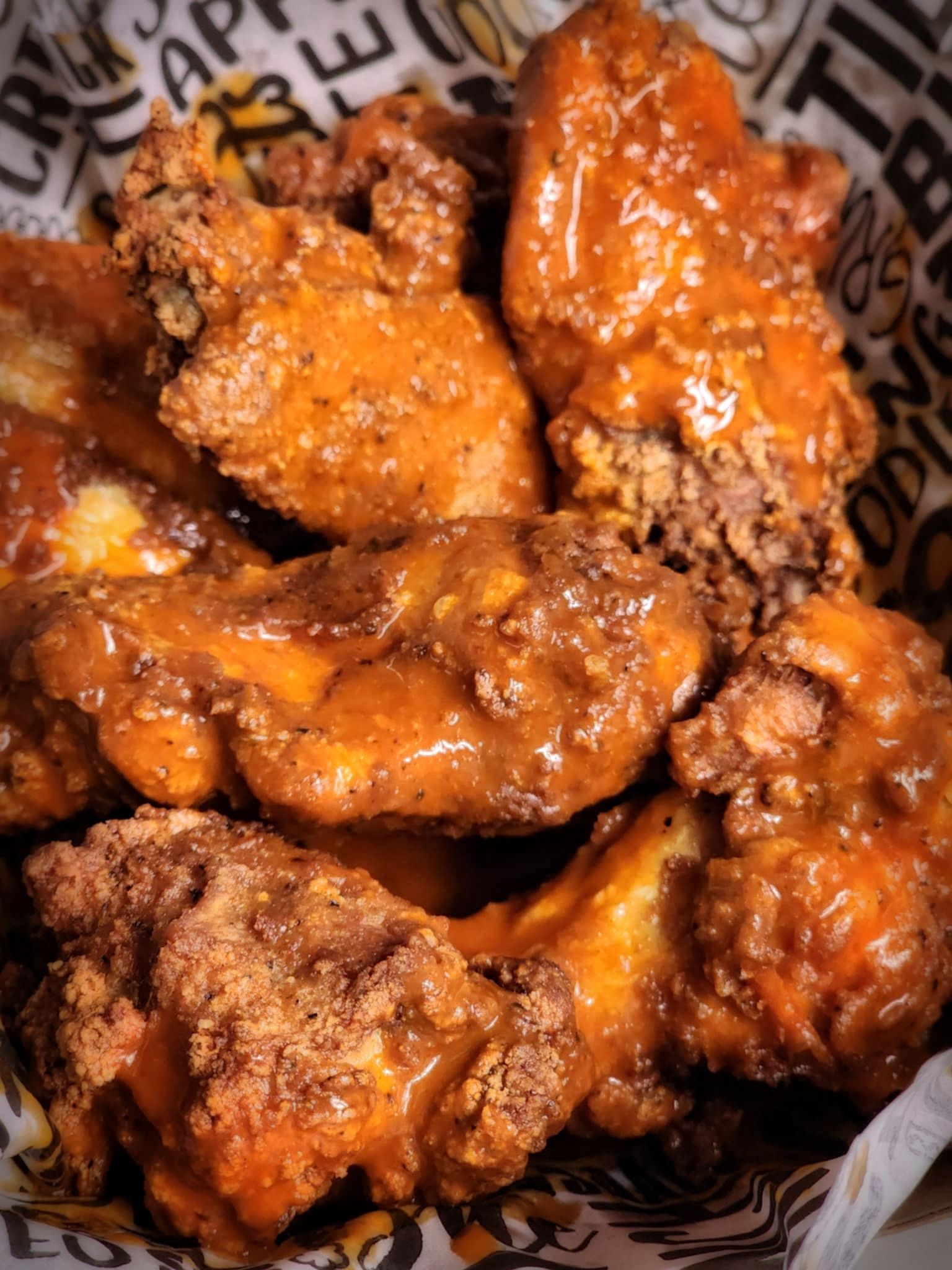 Fried chicken wings coated in buffalo sauce.