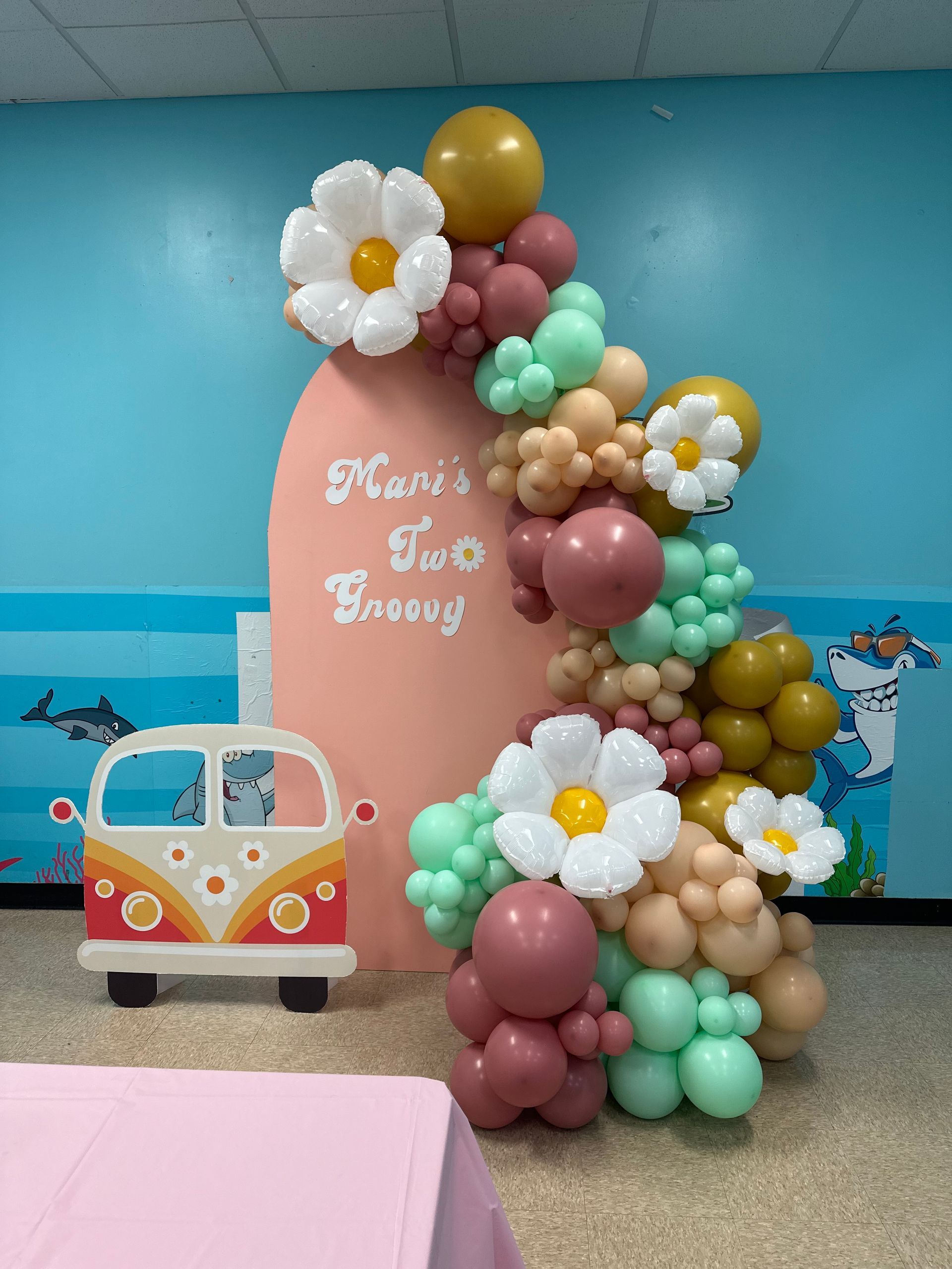 A bunch of balloons are sitting on a table in a room.