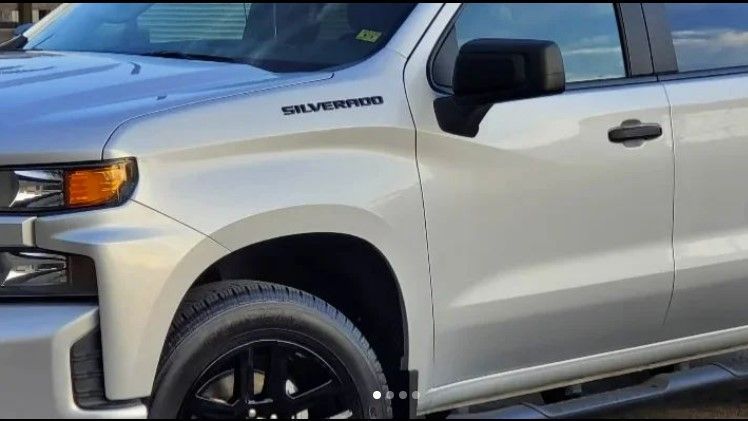 Silver Chevrolet Silverado pickup truck with black accents.