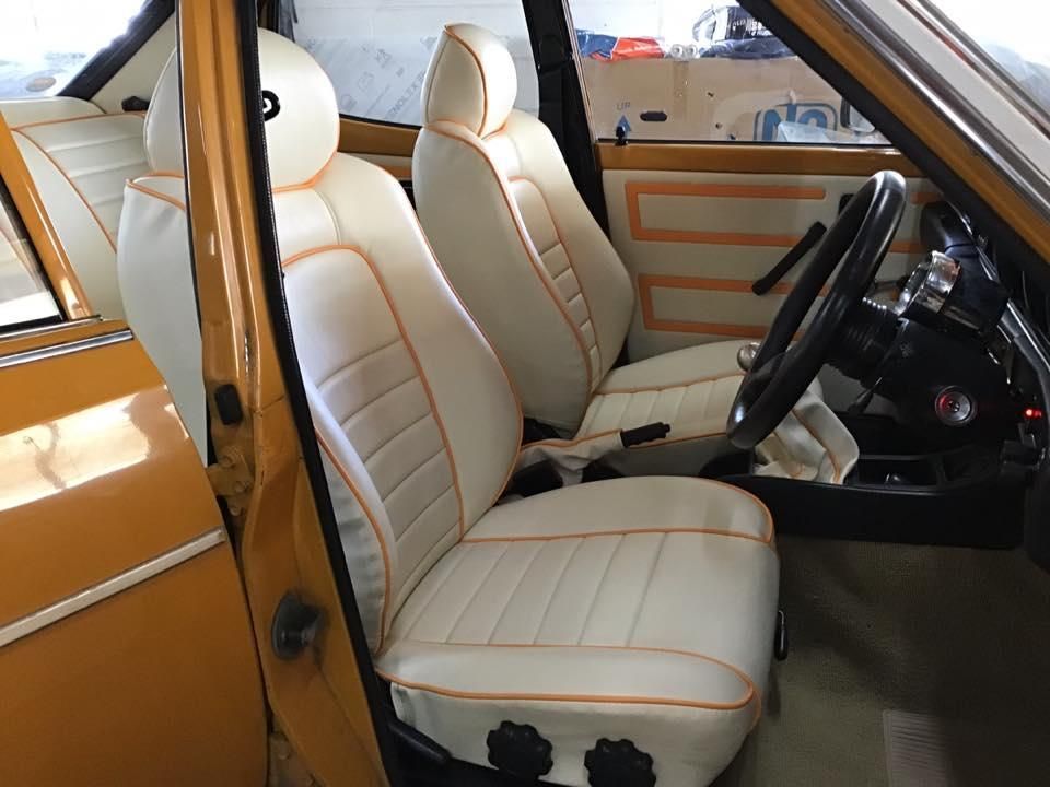 A Yellow Car With White Seats and a Steering Wheel — Isa Auto Glass & Upholstery In Menzies, QLD