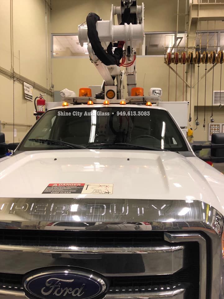 A white ford truck is parked in a garage.