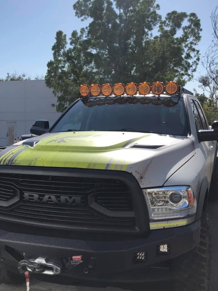 A ram truck with a hood light on top of it