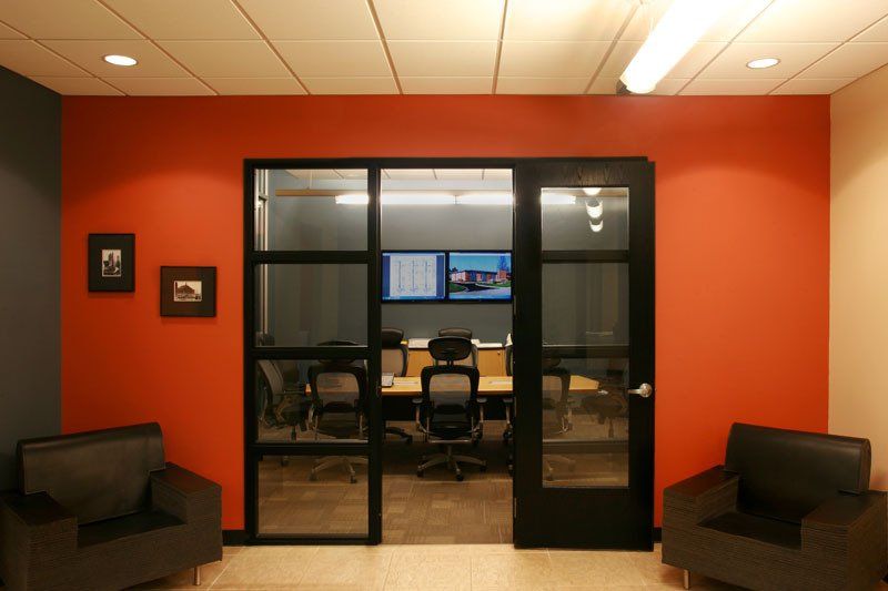 A conference room with two chairs and a table