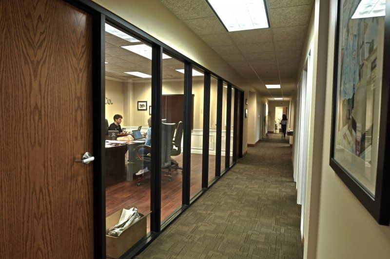 A hallway in an office building with a picture on the wall