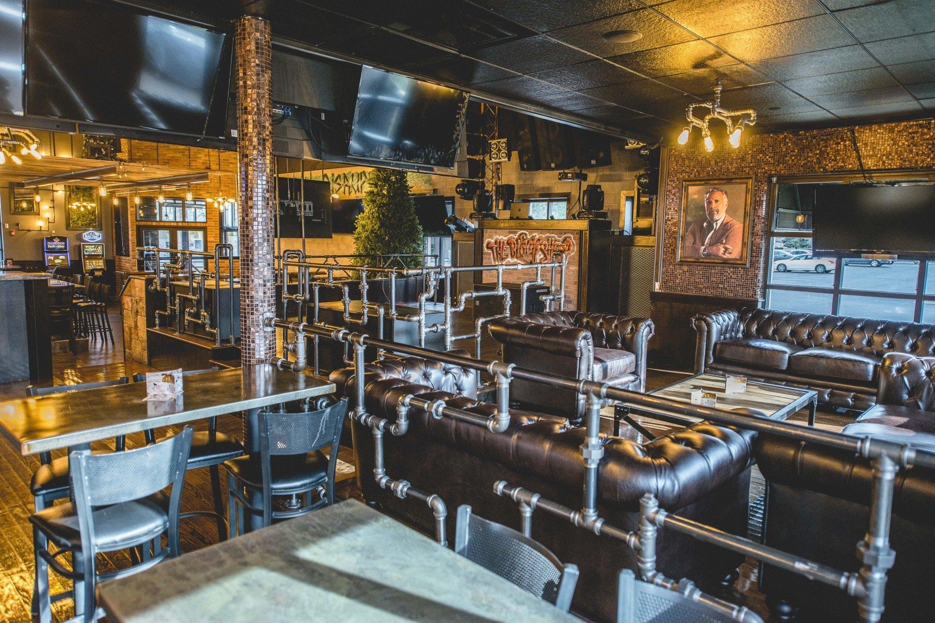 A restaurant with tables and chairs and a couch.