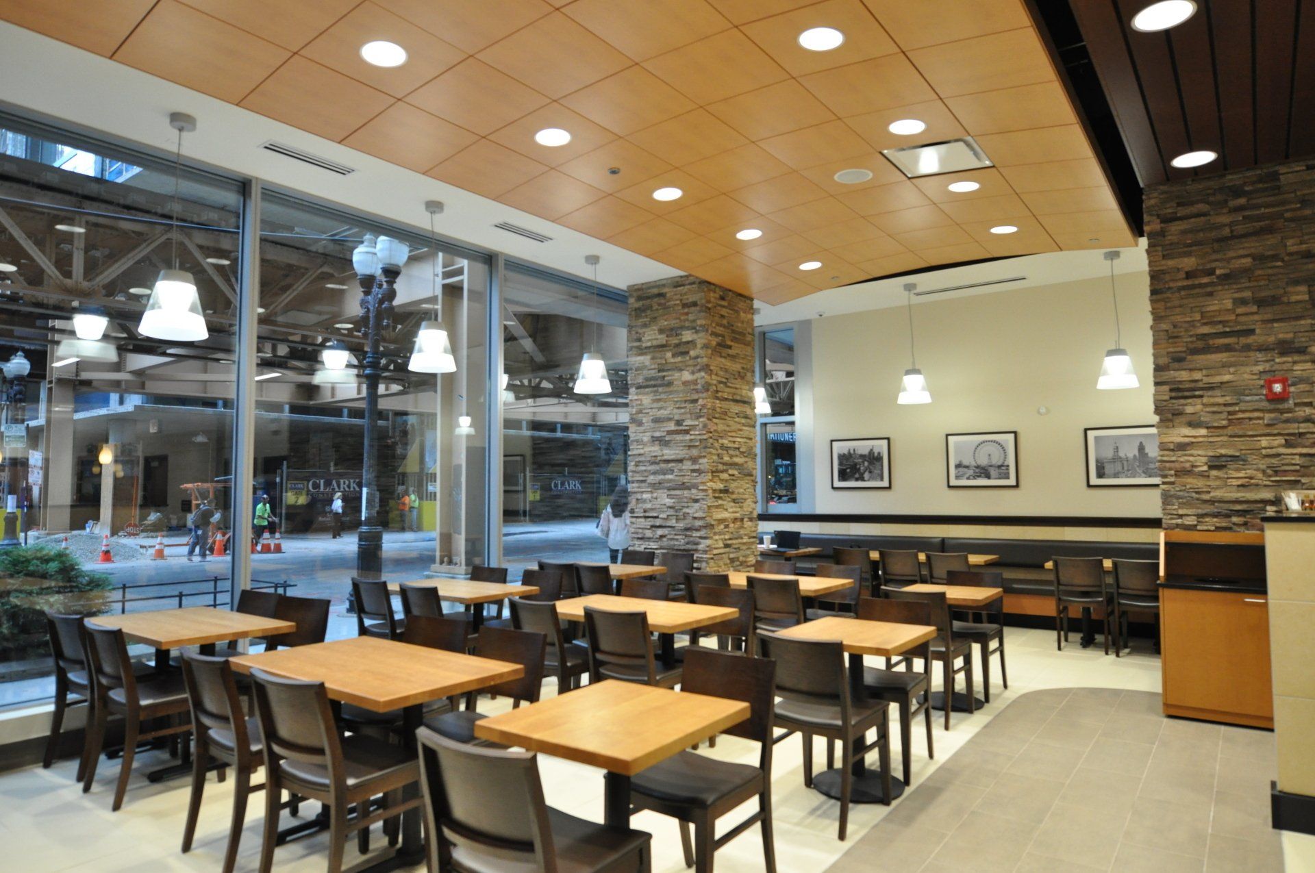A restaurant with tables and chairs and a large window