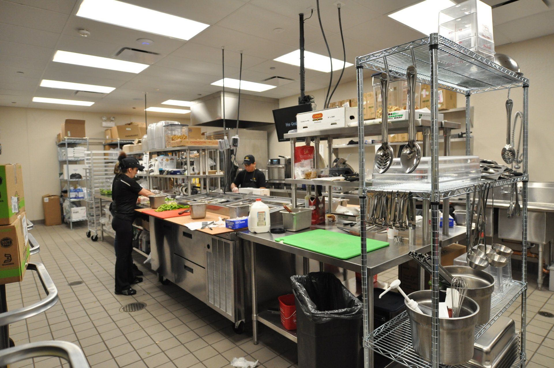 A man is standing in a kitchen preparing food.
