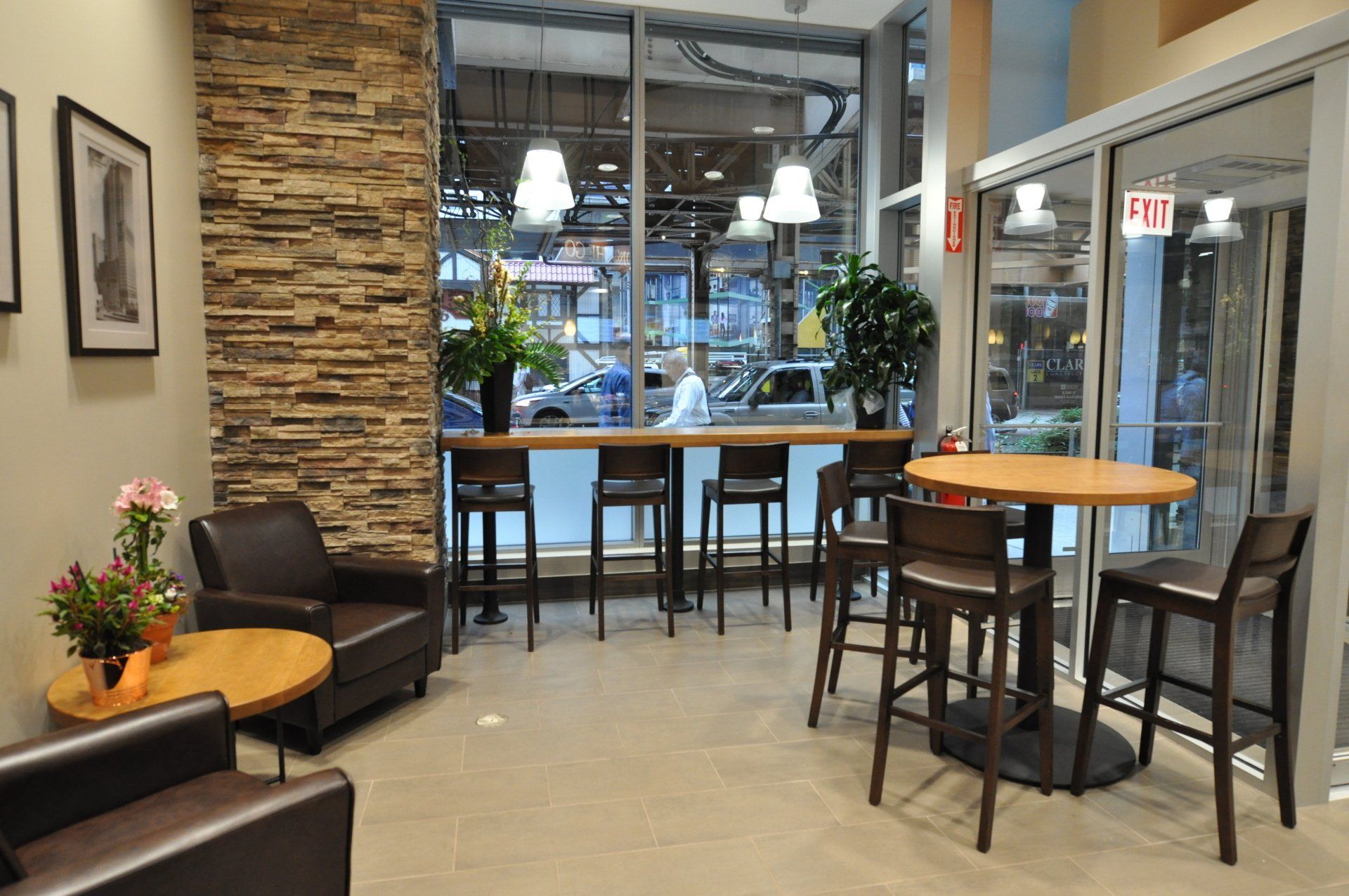 A room with tables and chairs and a sign that says exit