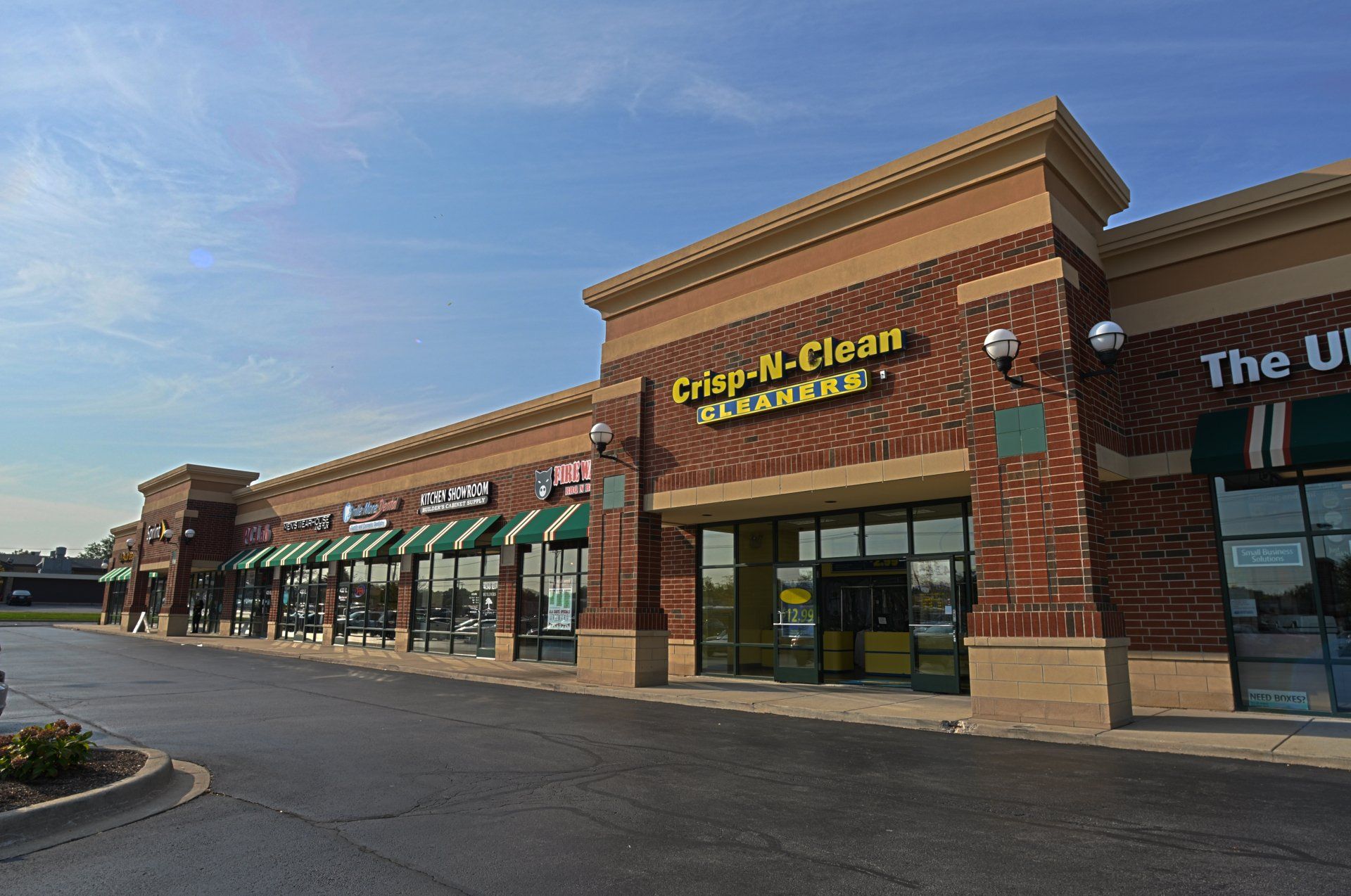 A brick building with a sign that says crisp n clean