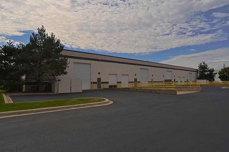 A large building with a lot of doors and trees in front of it