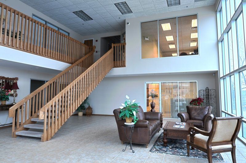 A living room with stairs leading up to the second floor