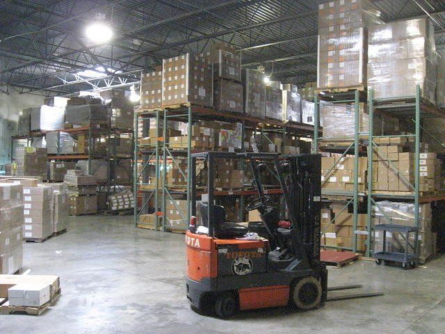A forklift is parked in a large warehouse