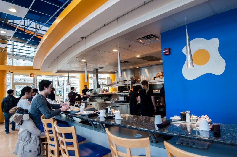 A restaurant with a blue wall and a fried egg on it