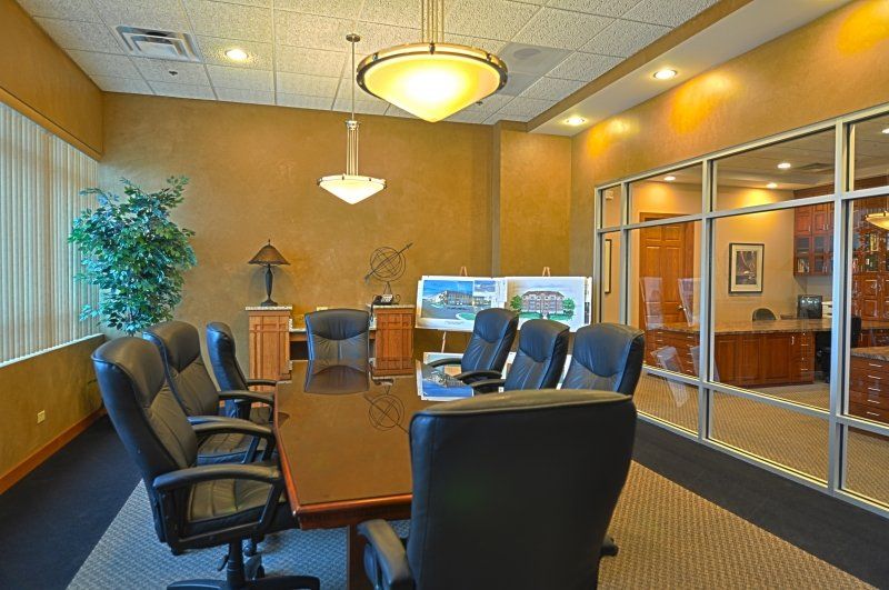 A conference room with a long table and chairs