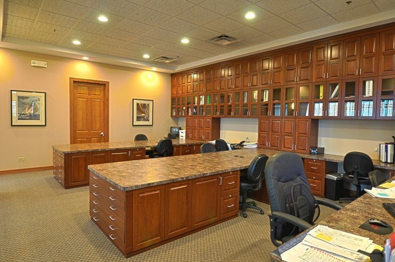 A large office with a lot of desks and chairs.