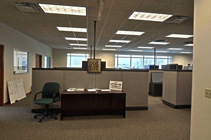An empty office with cubicles and a desk