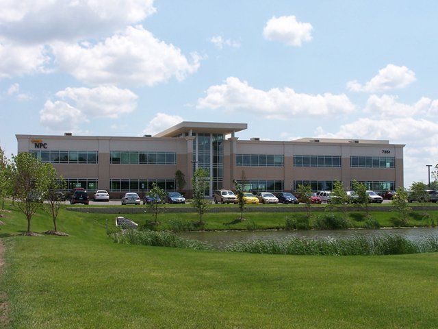 A large building with cars parked in front of it