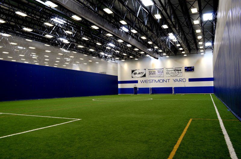 A large indoor soccer field with a sign that says wentmont yard