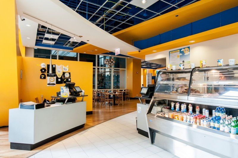 The inside of a restaurant with a counter and a display case.