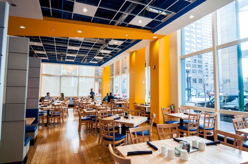 A restaurant with a lot of tables and chairs