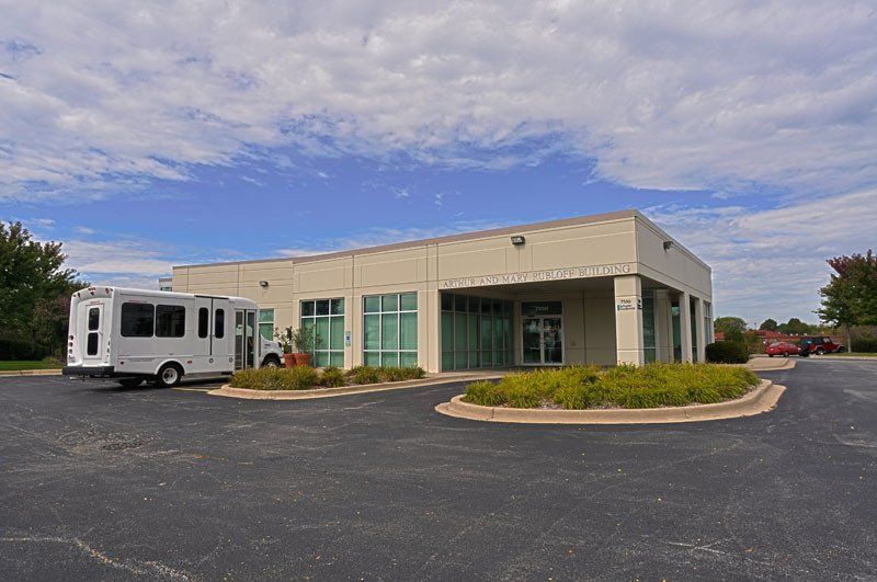 A white van is parked in front of a building
