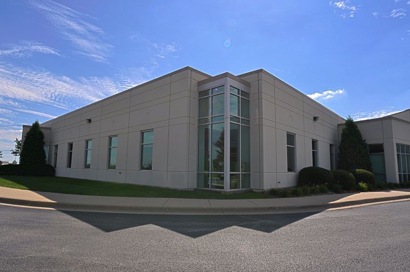 A large white building with a lot of windows on a sunny day