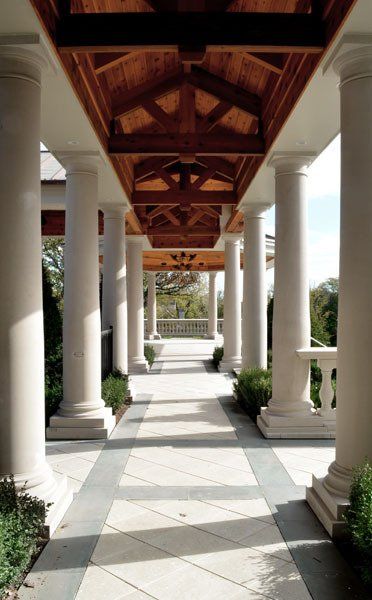 A long hallway with columns and a wooden ceiling
