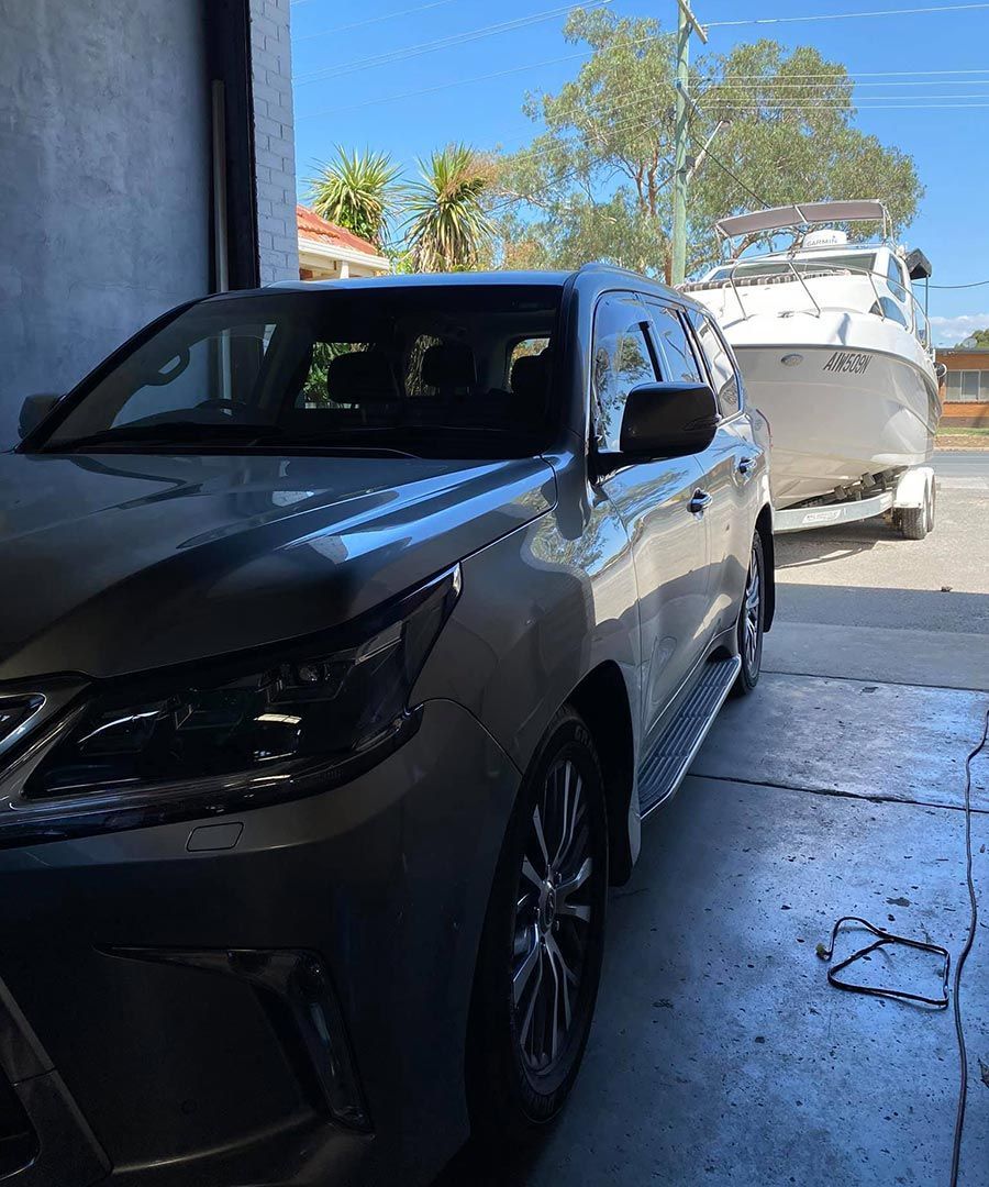 SUV with a Boat in a Trailer on Lavington Auto Electrical's Premises  — Lavington Auto Electrical in Lavington, NSW