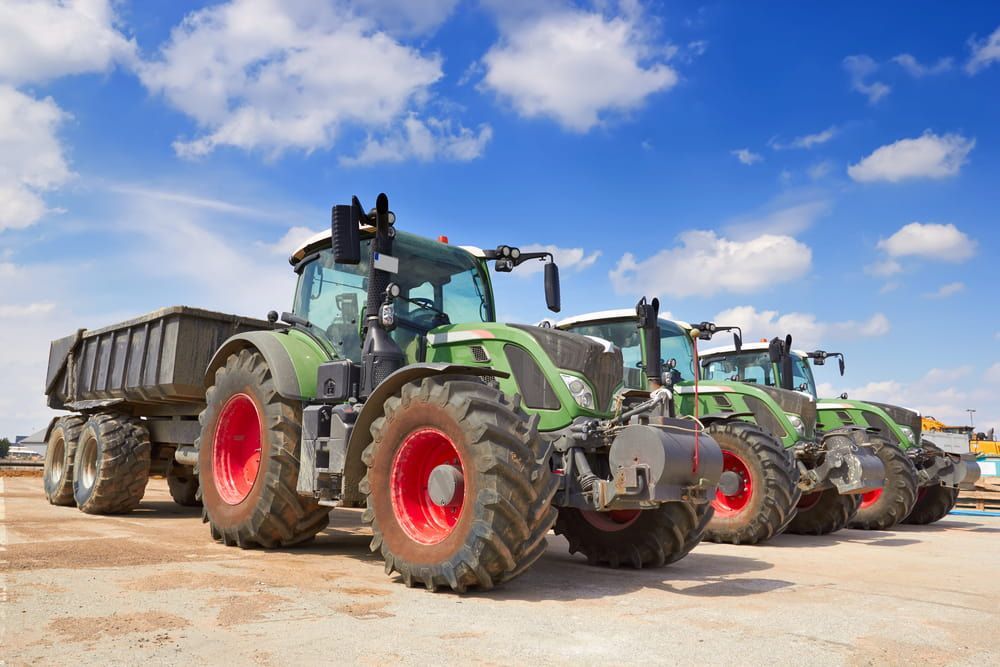 A Row of Tractors Parked Next to Each Other on a Dirt Road — Lavington Auto Electrical in Rutherglen, VIC