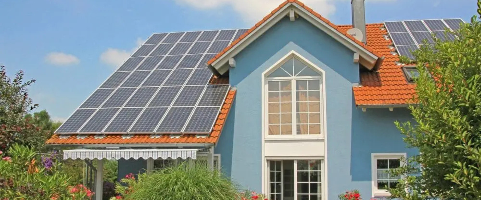 Green home construction with solar panels and energy-efficient design.