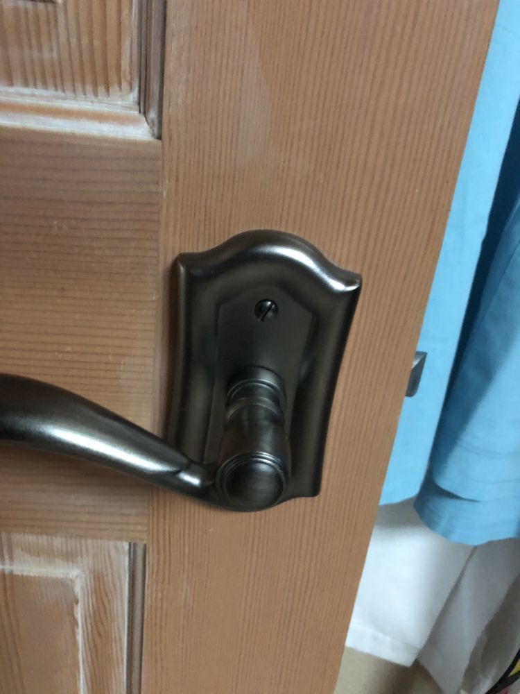 A large house with a lot of windows and a garage on a rainy day.