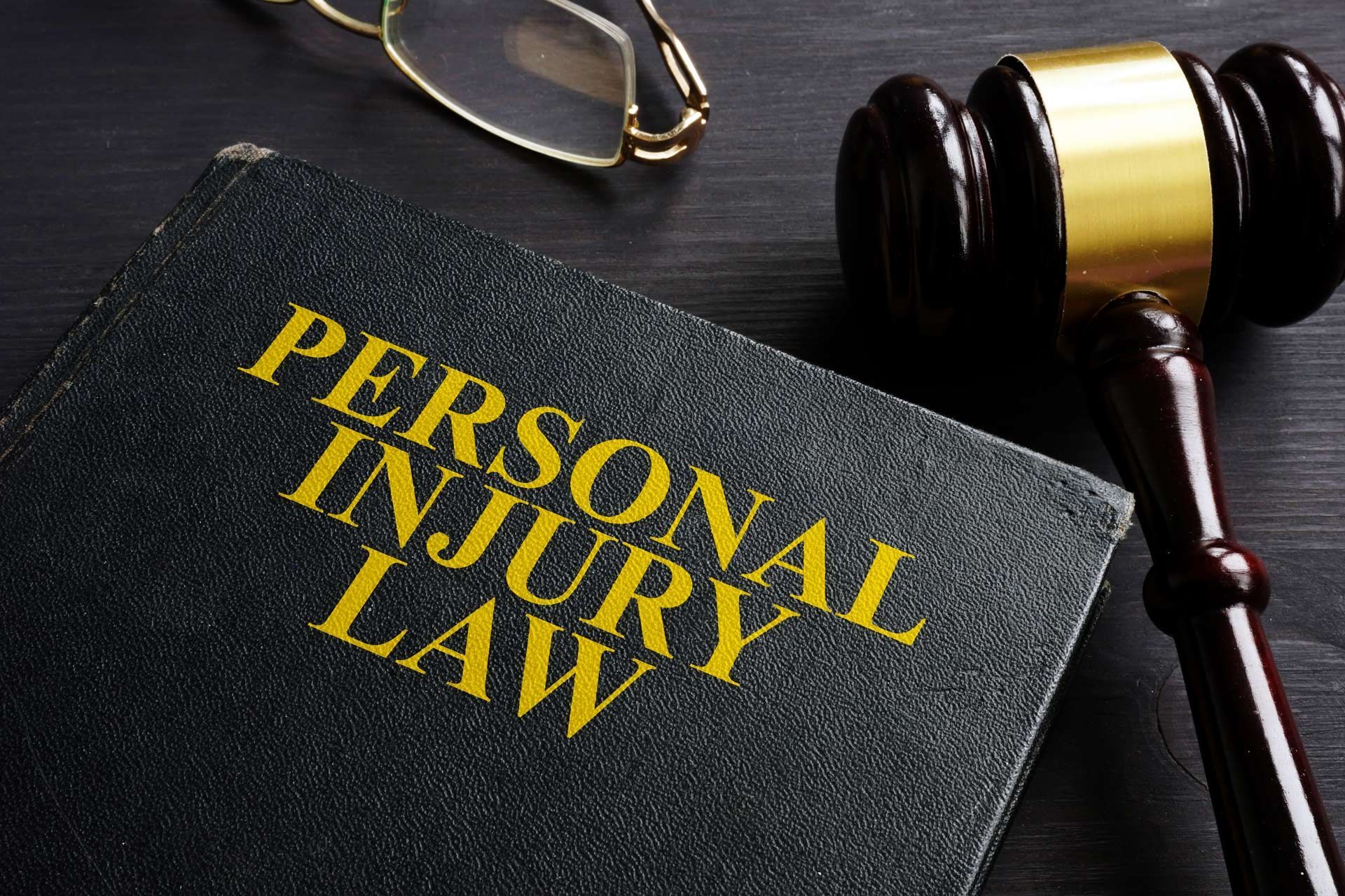 Legal reference book on desk, highlighting work done by a personal injury lawyer in cases.