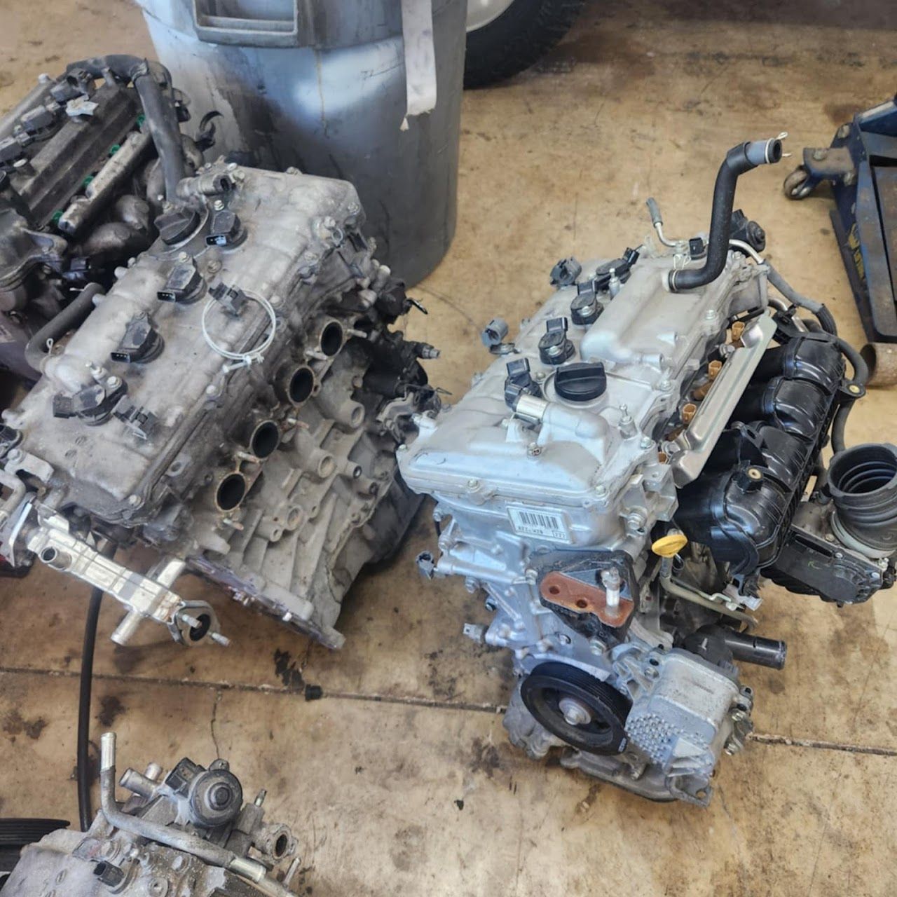 Three dismantled car engines on a concrete floor | Lucky Autolabs