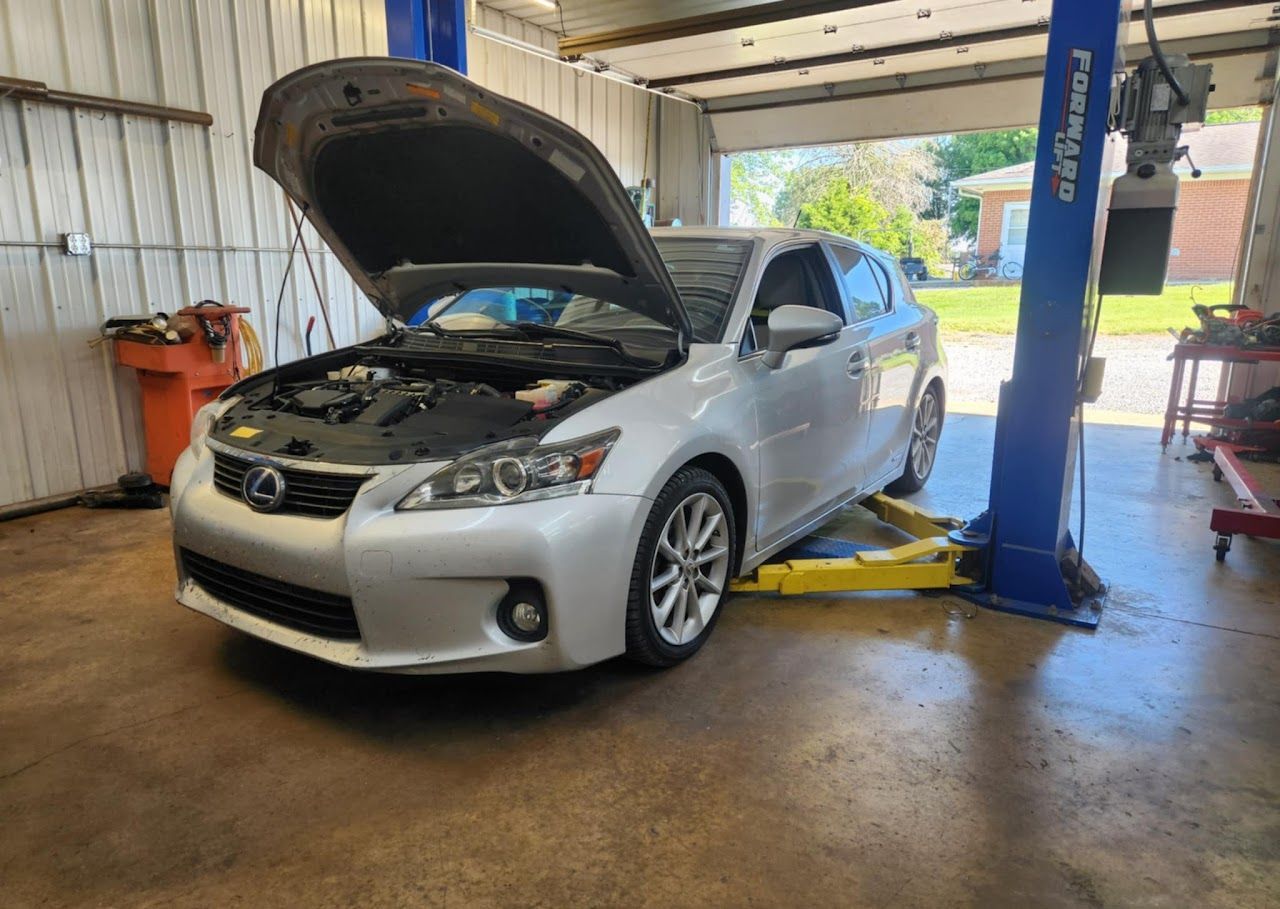 Silver Lexus CT 200h with hood open in a repair shop | Lucky Autolabs